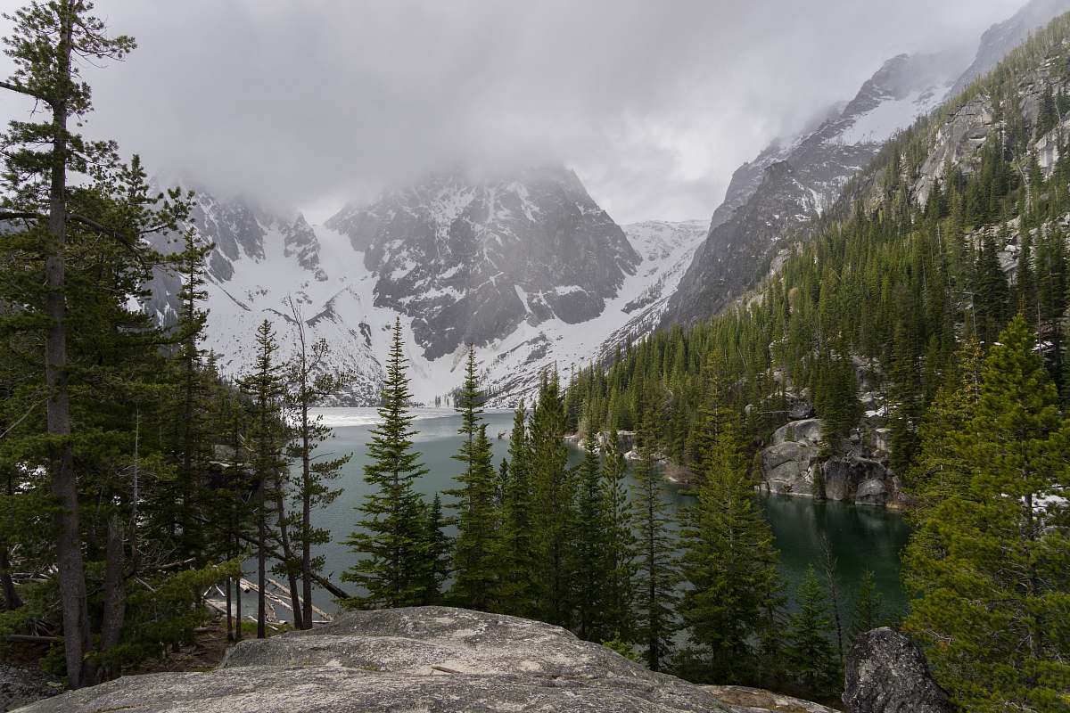 mountain range gray rock mountain leading to river and coated snow mountain nature